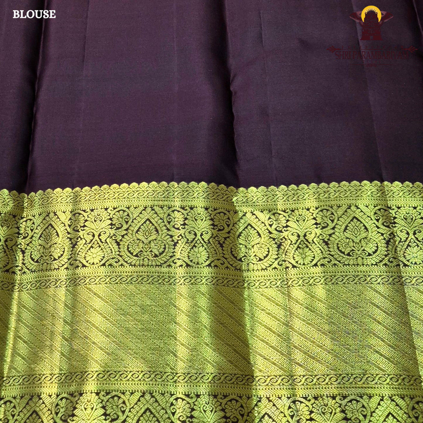 A bright orange with a rich coffee brown and gold korvai border Saree