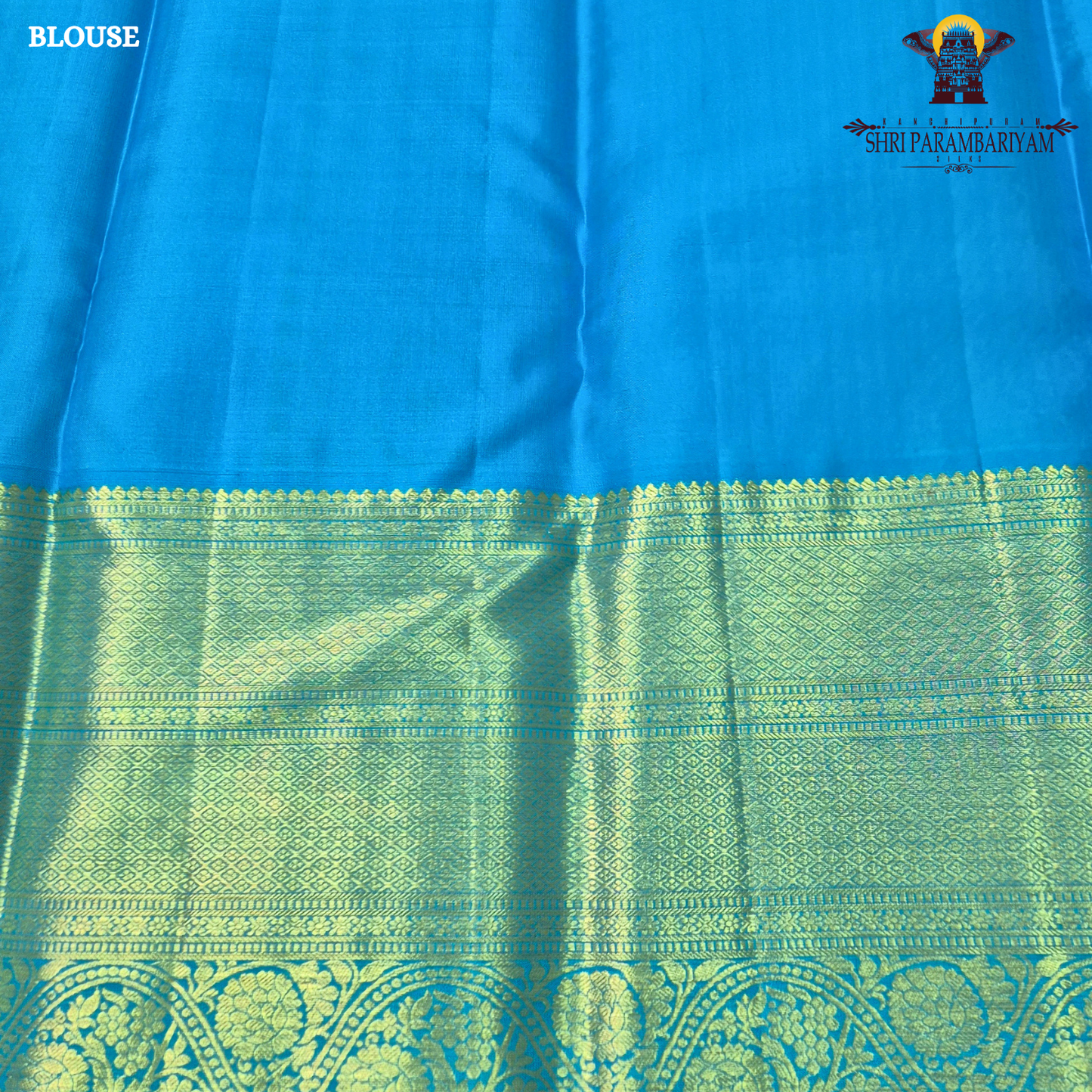 A rich violet purple body with a contrasting sky blue korvai border Saree