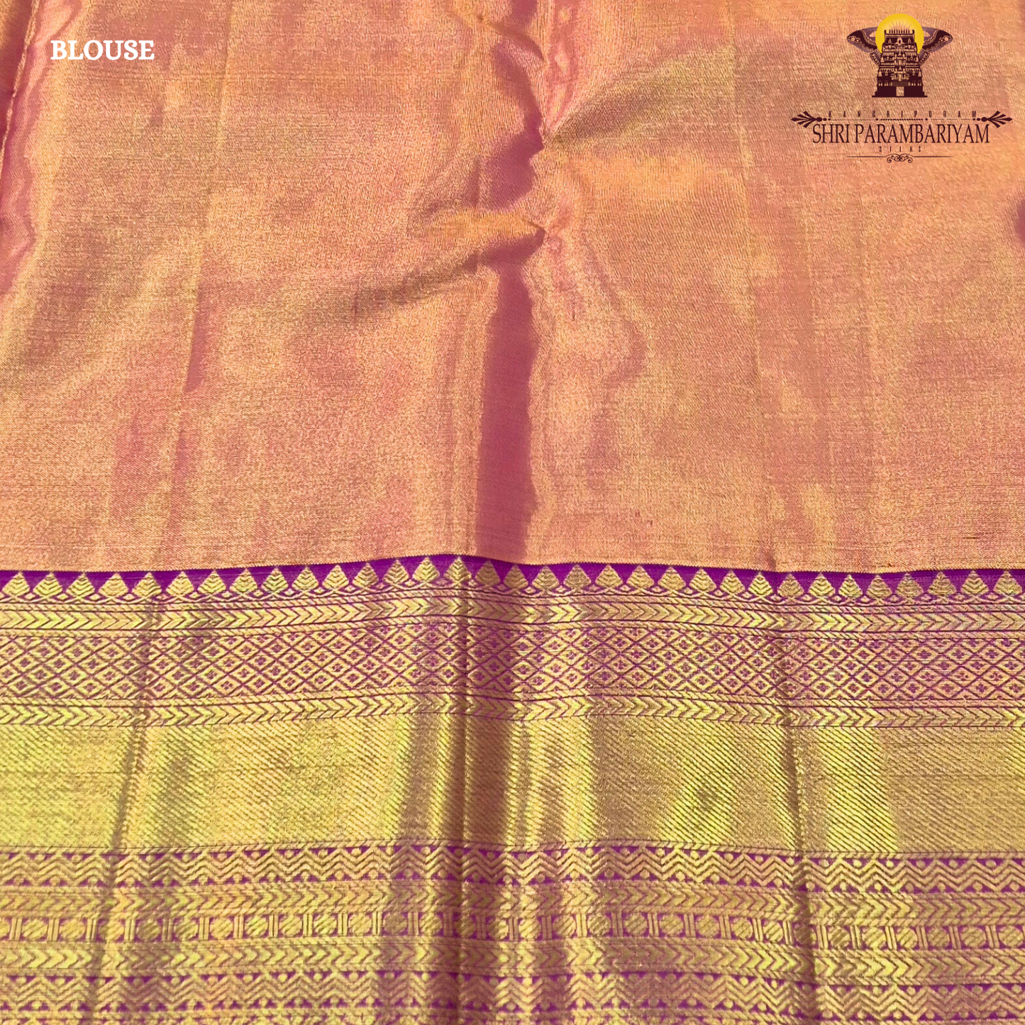 A Soft pastel peach with rich gold zari work and a contrasting deep magenta (rani pink) border Saree