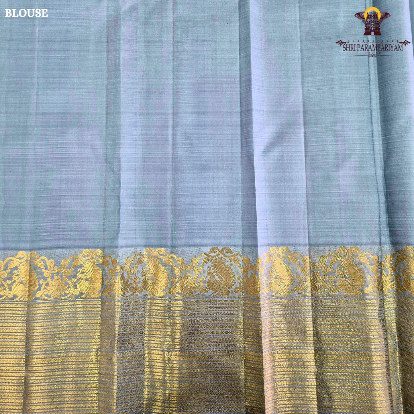 A soothing Ice Blue shade, adorned with graceful gold zari floral buttas Saree