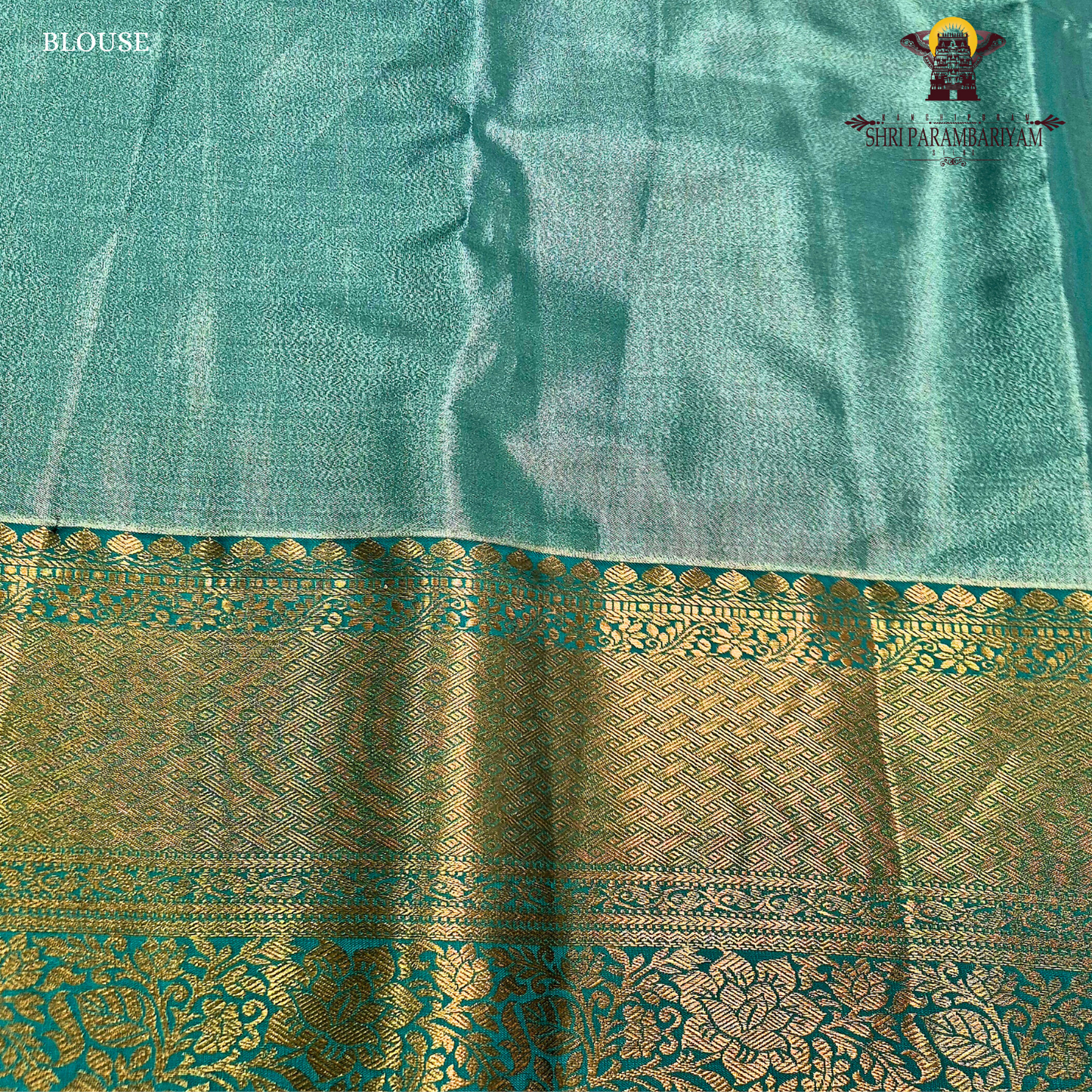 Elegant antique gold body paired with a rich teal green border Saree