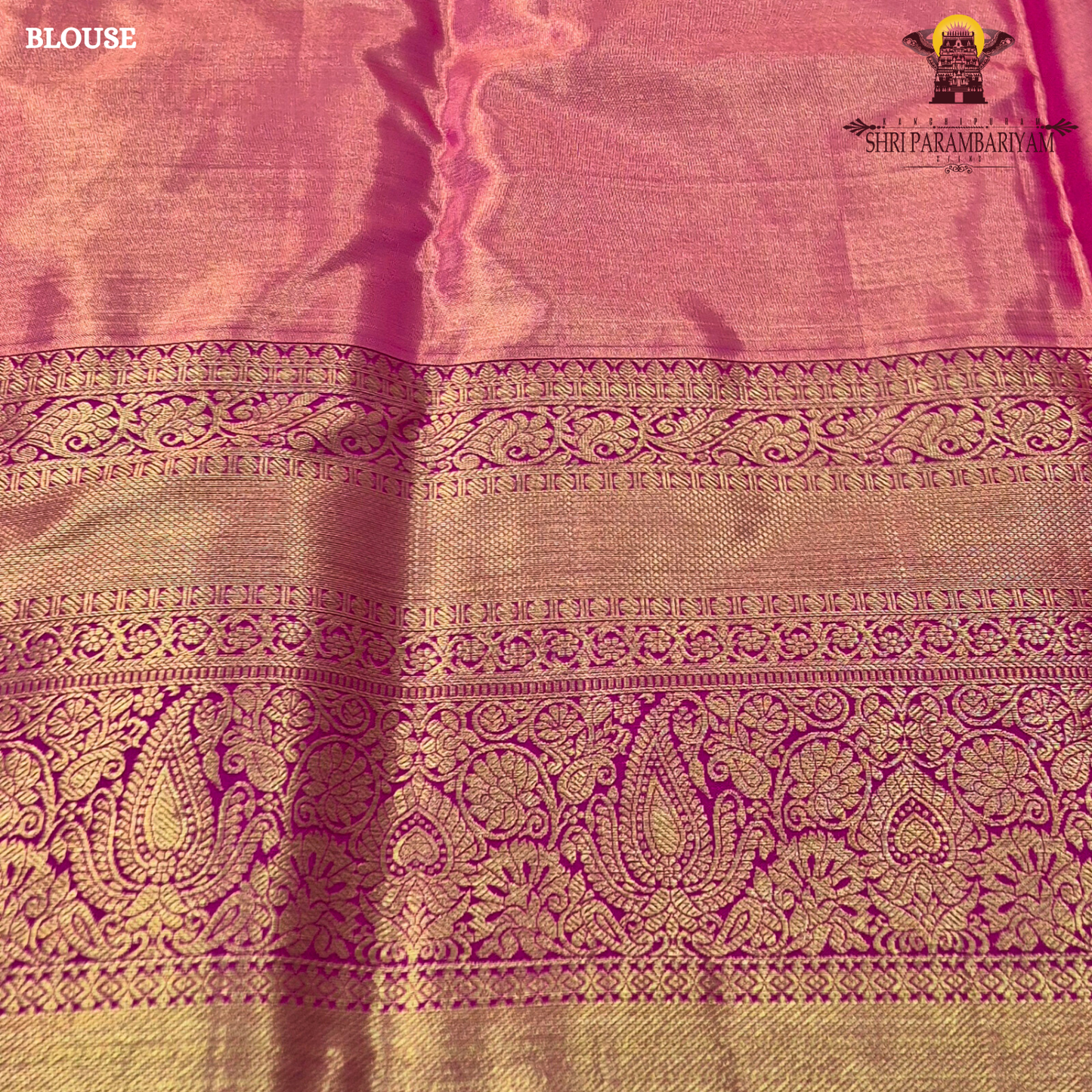 A sophisticated antique gold / champagne gold tissue body paired with a vibrant bright rani pink border Saree