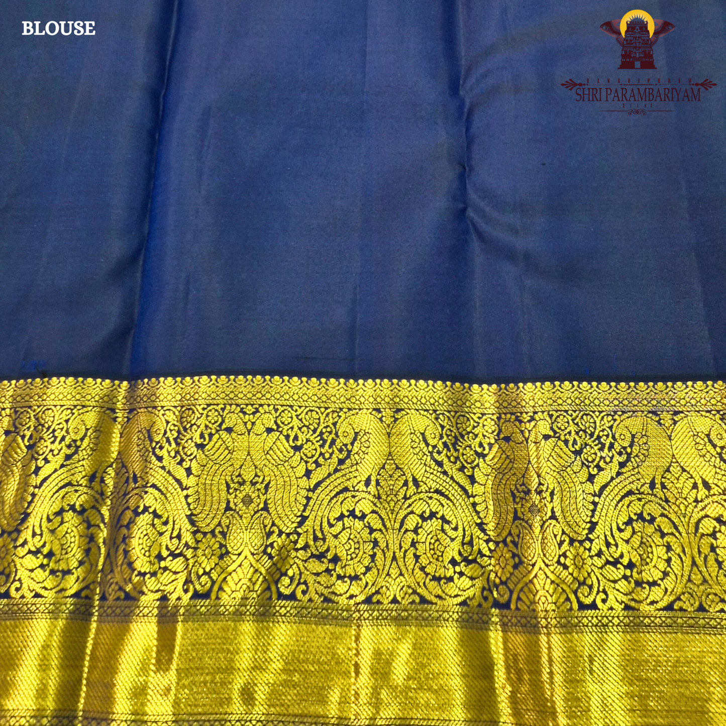 A bright parrot green body paired with a royal navy blue border richly woven Saree