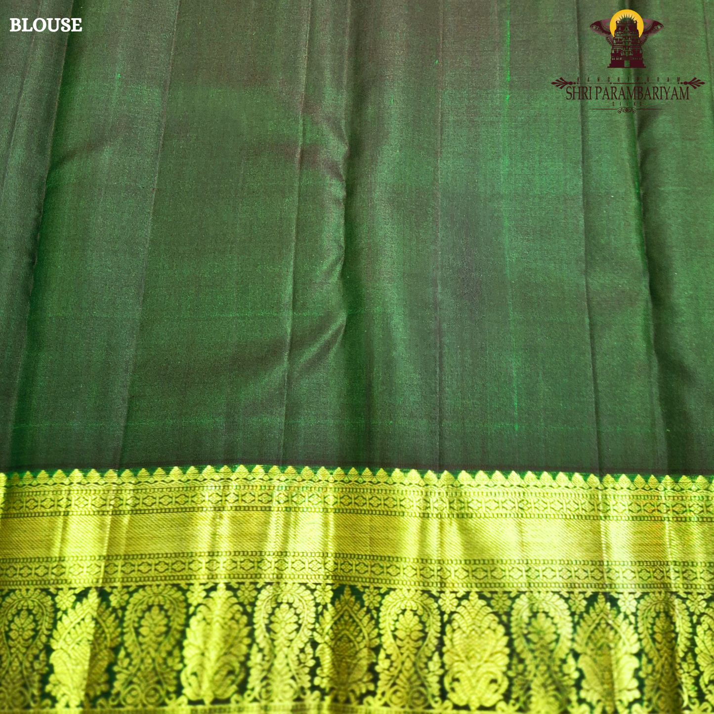 A deep bottle green and antique gold combination with an elegant zari Saree