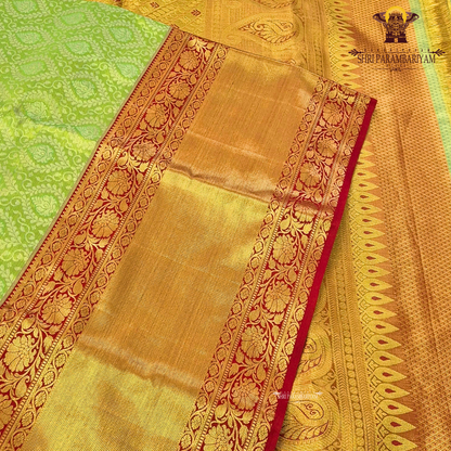 A vibrant combination of parrot green and rich gold Saree