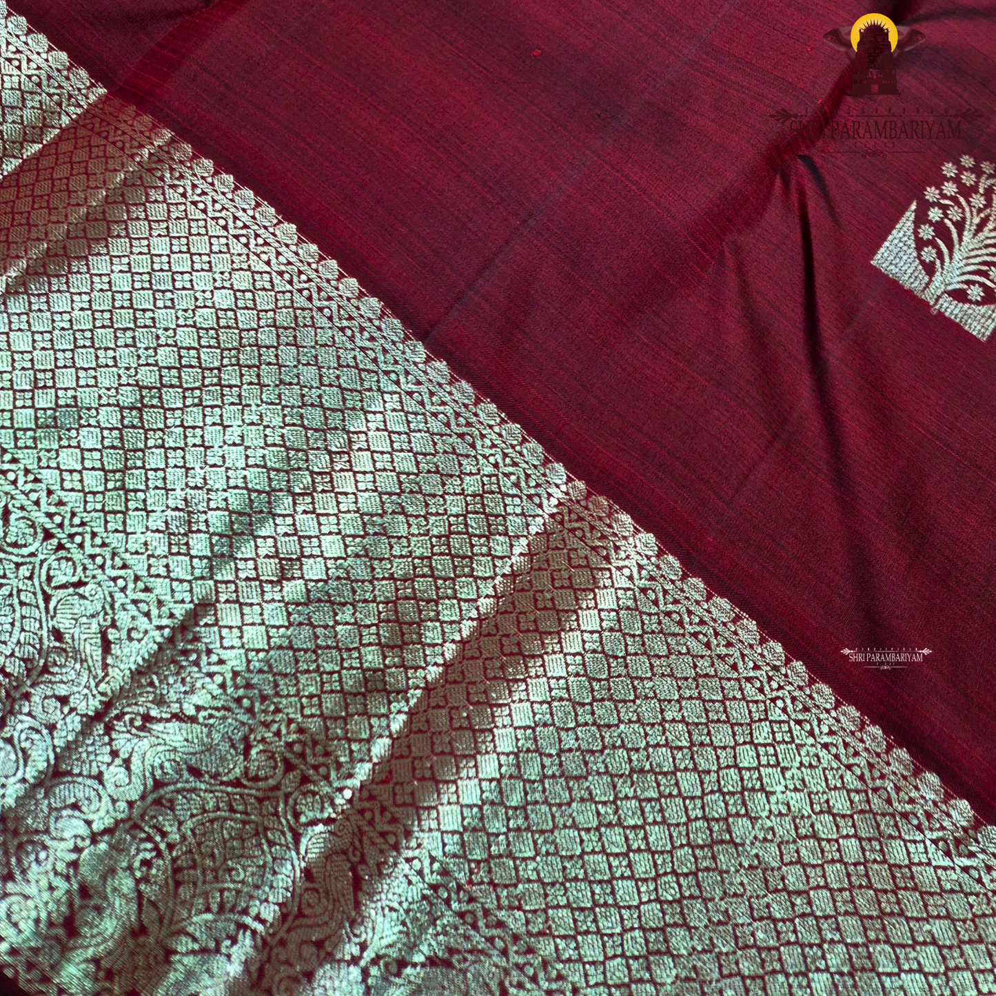 A rich dual-tone deep maroon with subtle wine undertones Saree