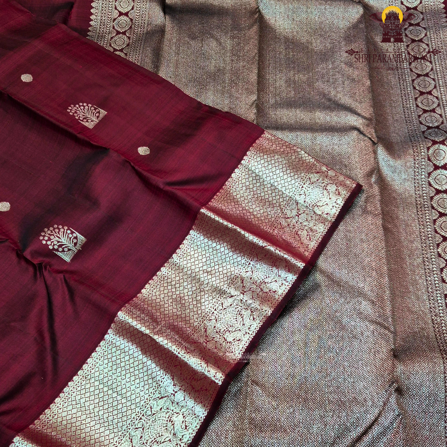 A rich dual-tone deep maroon with subtle wine undertones Saree