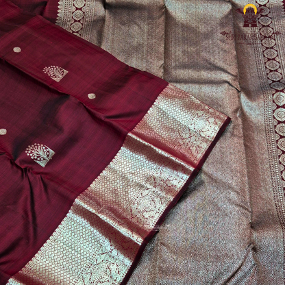 A rich dual-tone deep maroon with subtle wine undertones Saree