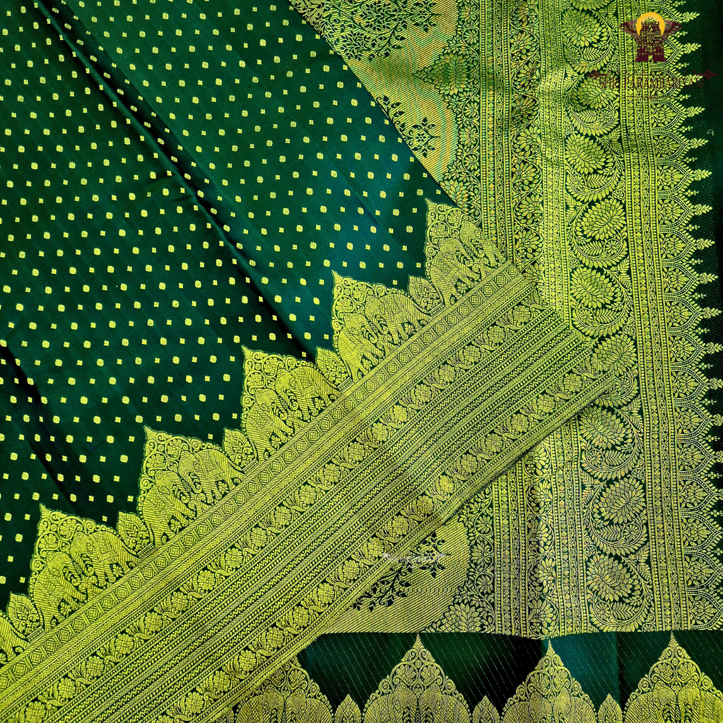 A classic Deep Green body adorned with finely woven gold zari Saree
