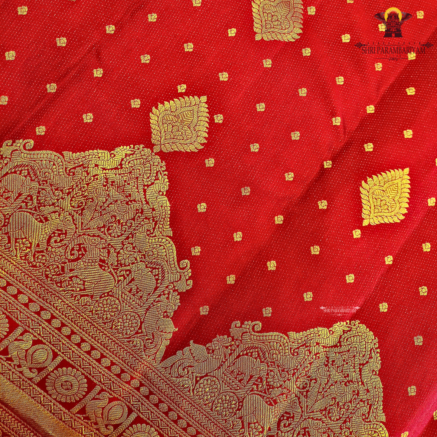 A rich Tomato Red / Vermilion Red body with elegant Golden Zari Saree