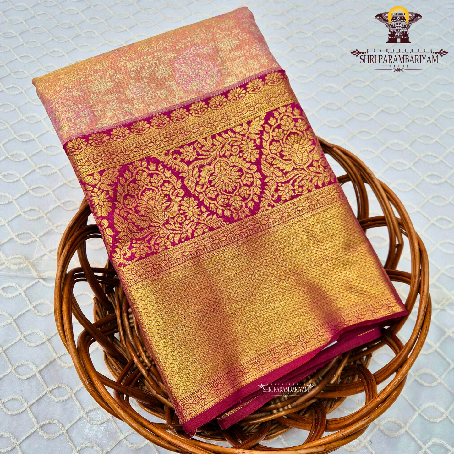 A soft peach tissue body paired with a rich magenta border Saree