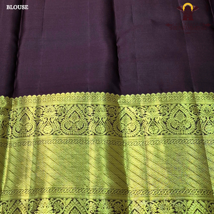 A bright orange with a rich coffee brown and gold korvai border Saree