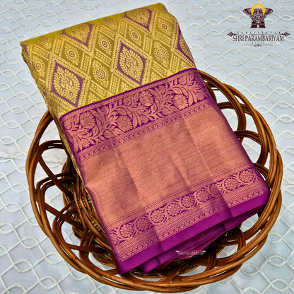 A mustard gold with a rich magenta purple korvai border and rose gold zari Saree