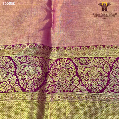 A soft peach tissue body paired with a rich magenta border Saree