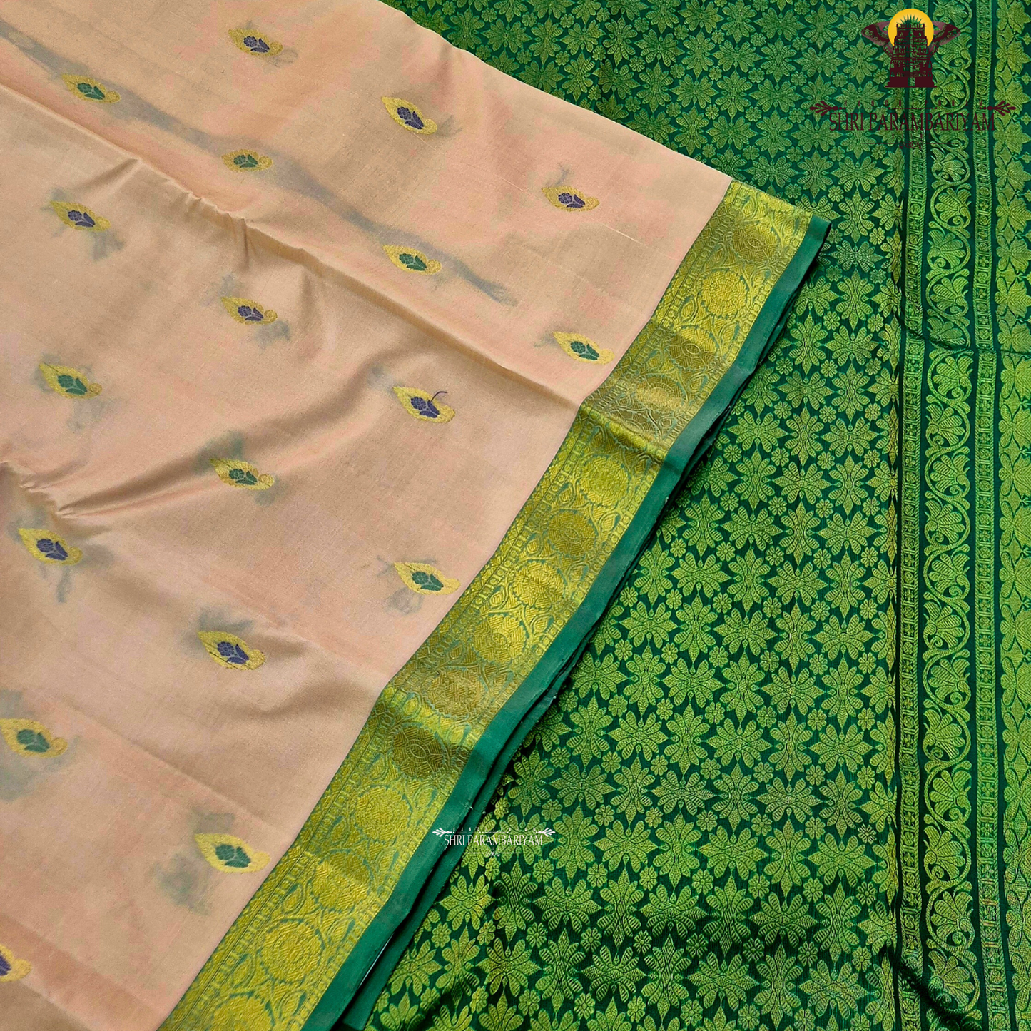 Soft peach-beige body paired with a rich parrot green 2-inch border and subtle gold zari detailing Saree