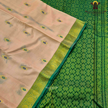 Soft peach-beige body paired with a rich parrot green 2-inch border and subtle gold zari detailing Saree