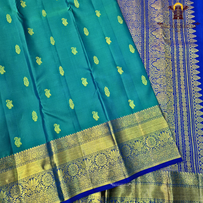 A rich Peacock Blue (teal blue tone) with Royal Blue and Gold zari border Saree