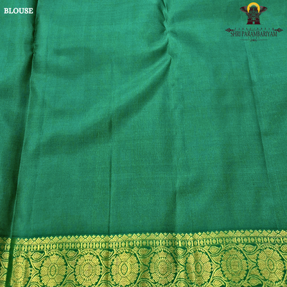 Soft peach-beige body paired with a rich parrot green 2-inch border and subtle gold zari detailing Saree
