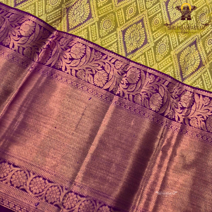 A mustard gold with a rich magenta purple korvai border and rose gold zari Saree