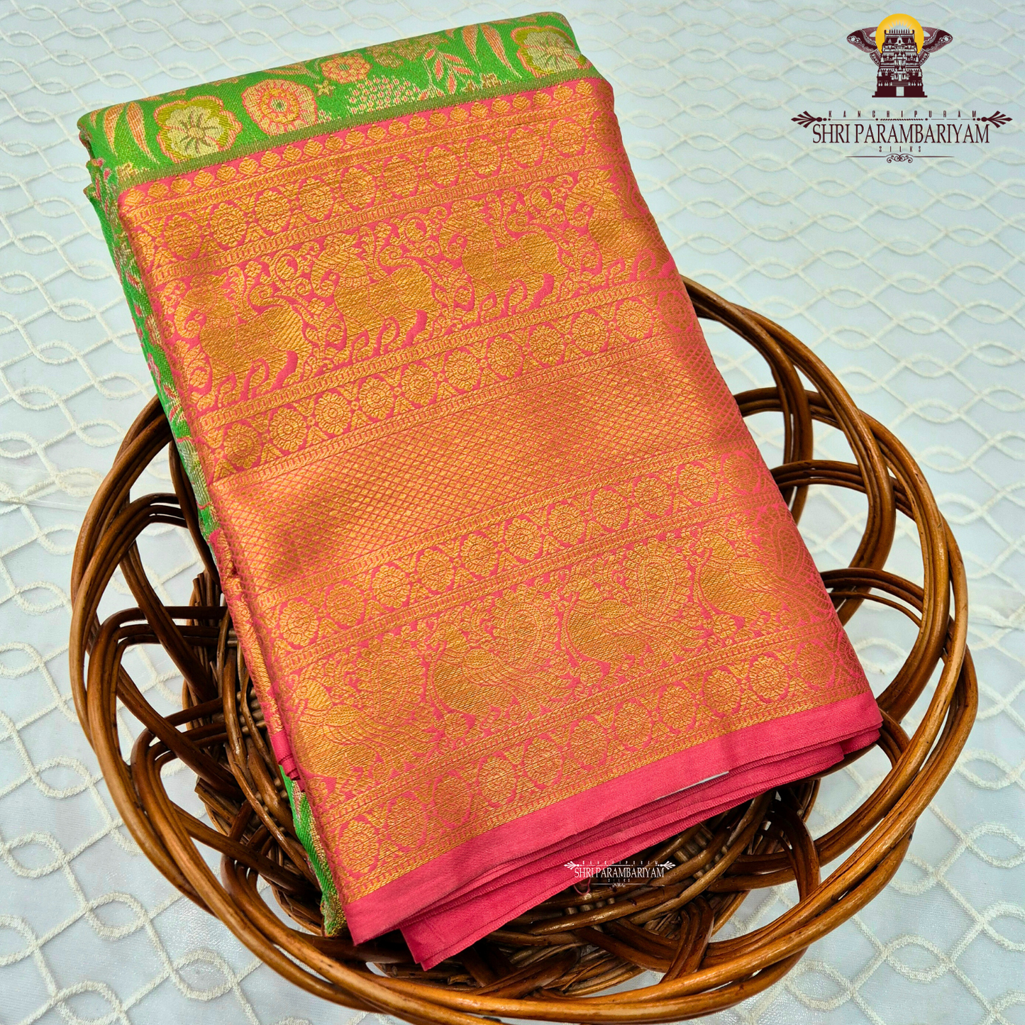 A vibrant rani pink tissue body paired with a contrasting parrot green border Saree