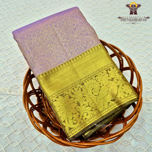 A beautiful pastel lavender (light purple with a rich antique gold zari border Saree