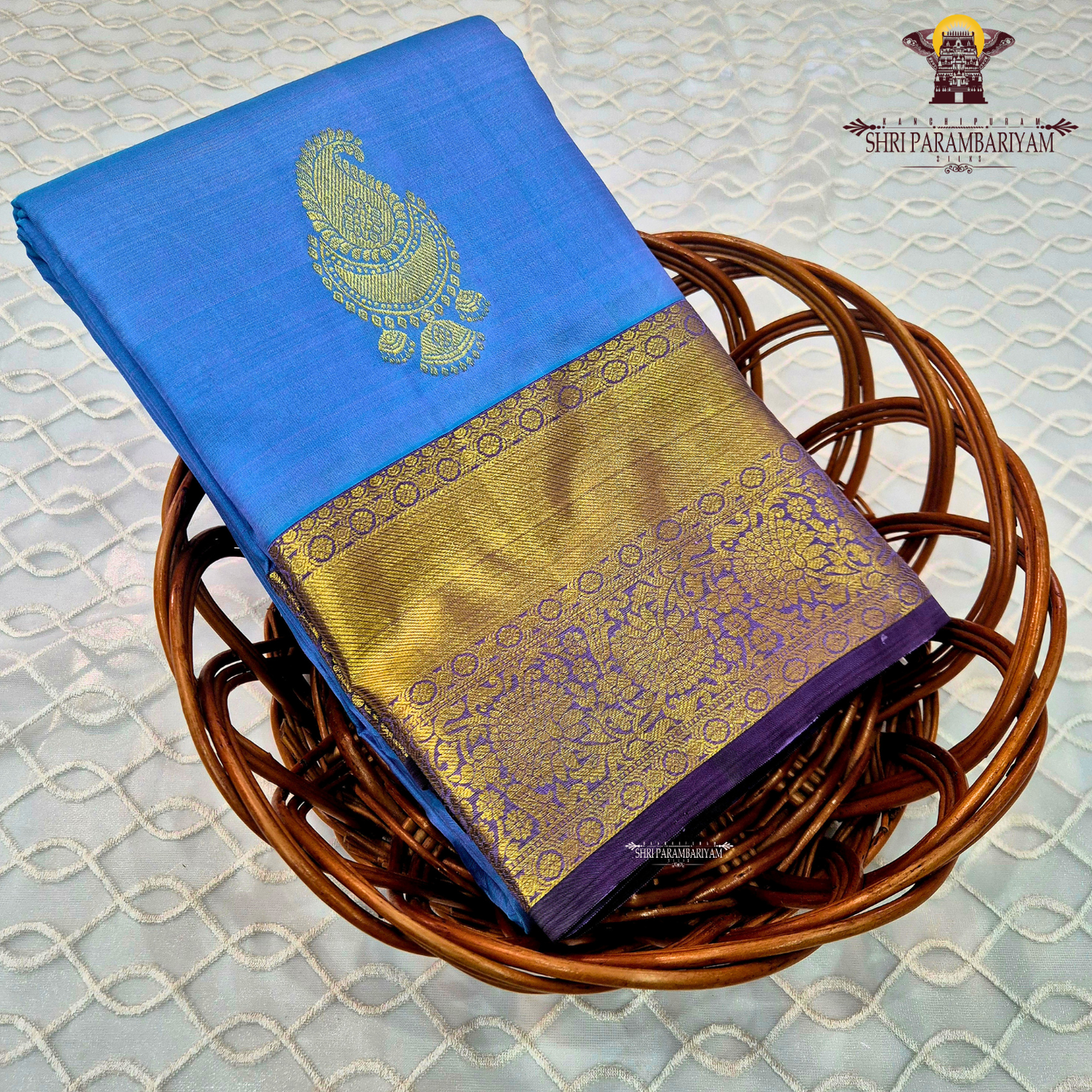 A rich Sky blue with a rich gold zari border and a contrasting royal purple edging Saree
