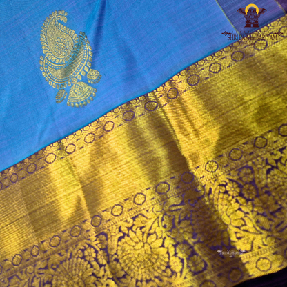 A rich Sky blue with a rich gold zari border and a contrasting royal purple edging Saree