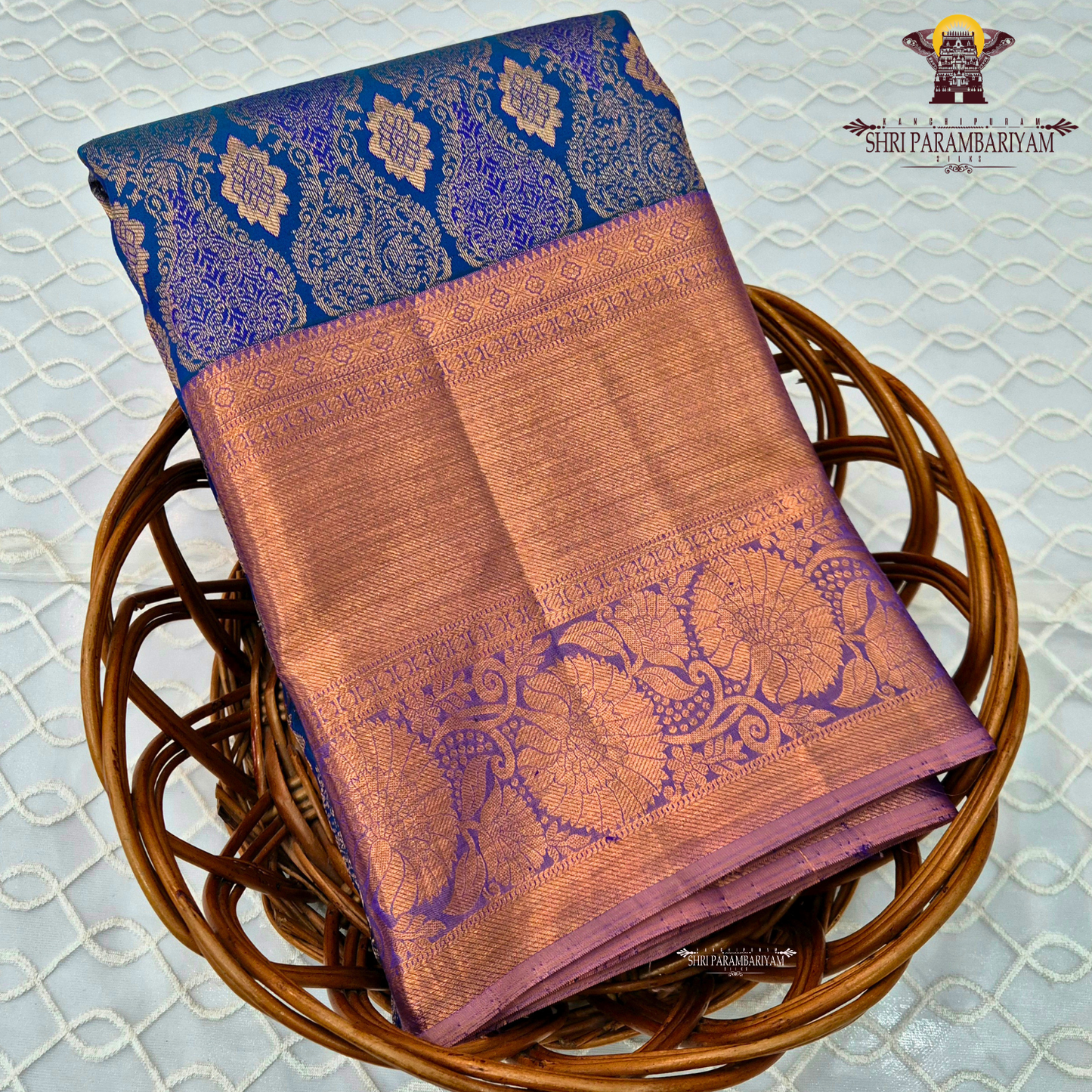 A royal blue with a lavender purple border and rich rose gold zari Saree
