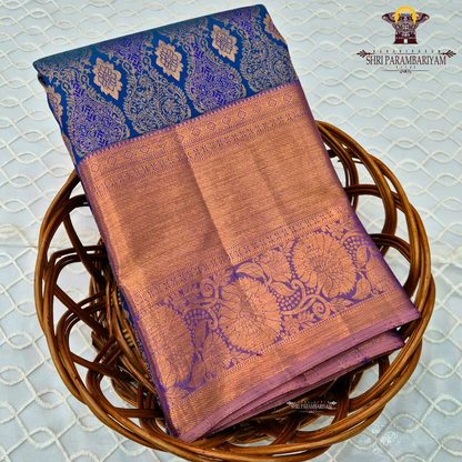 A royal blue with a lavender purple border and rich rose gold zari Saree