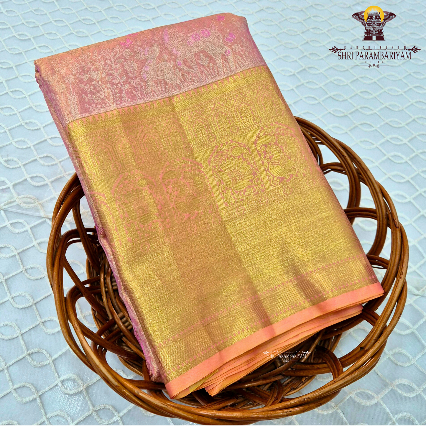 A soft and elegant peachy pink body complemented Saree