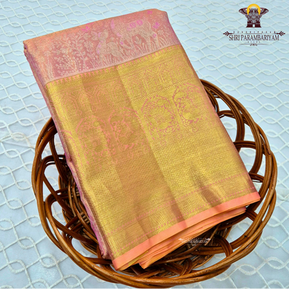 A soft and elegant peachy pink body complemented Saree