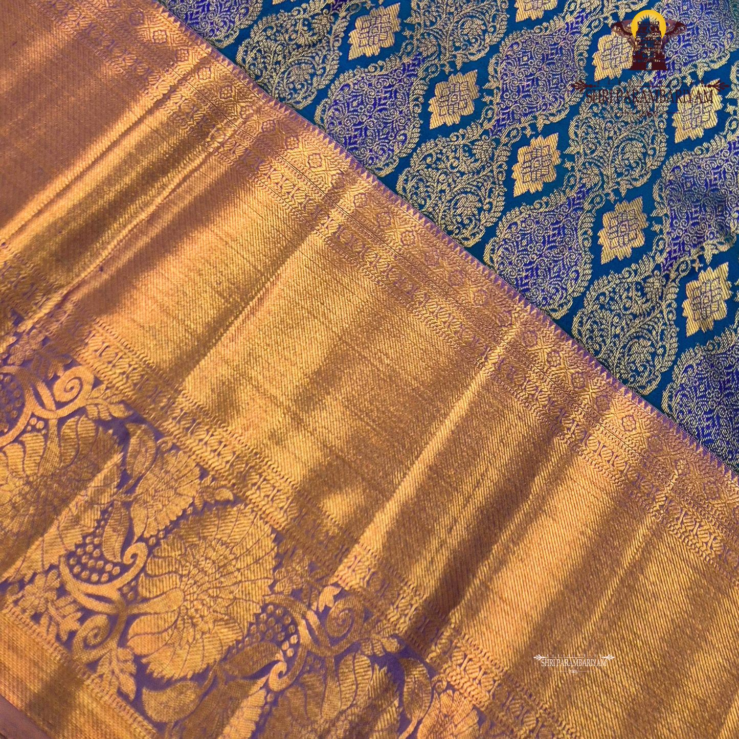 A royal blue with a lavender purple border and rich rose gold zari Saree