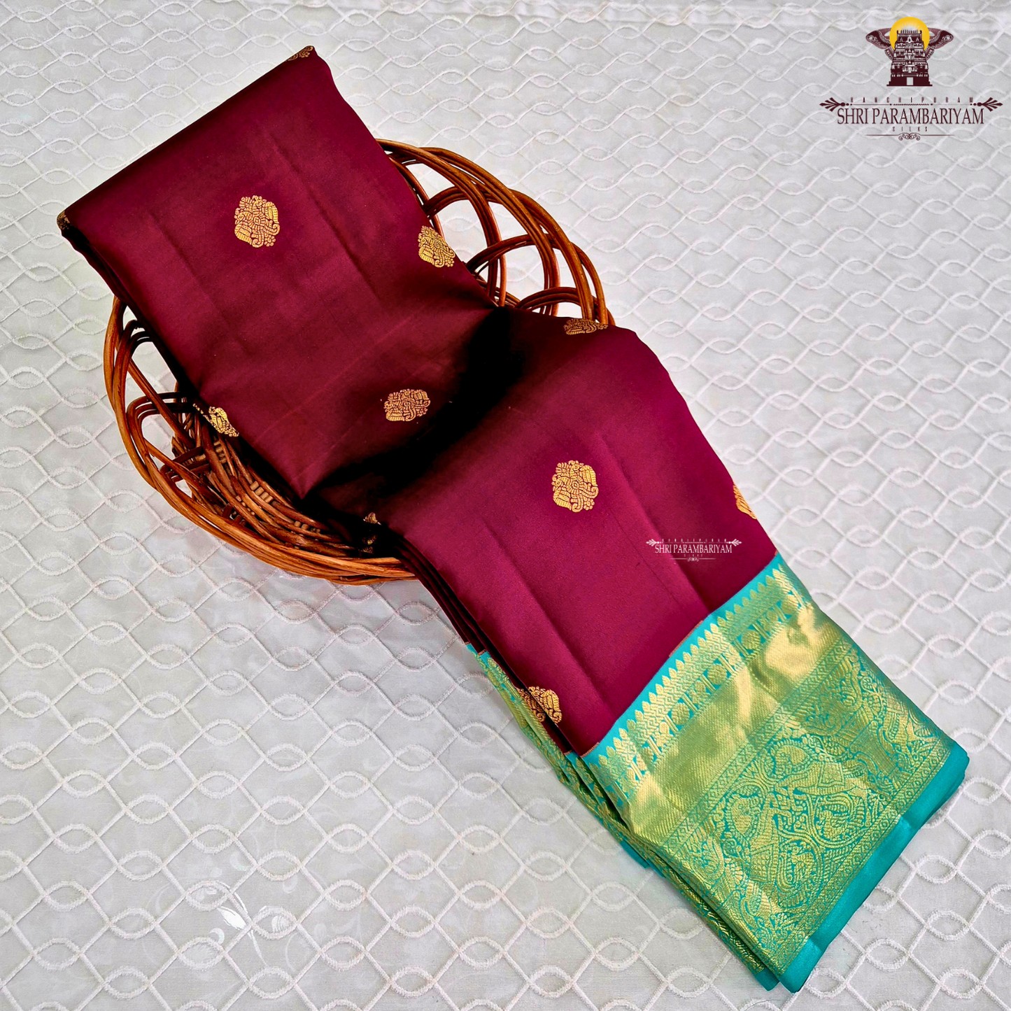 A rich Wine Magenta / Deep Rani Pink body with a contrasting Turquoise Blue Korvai Border Saree