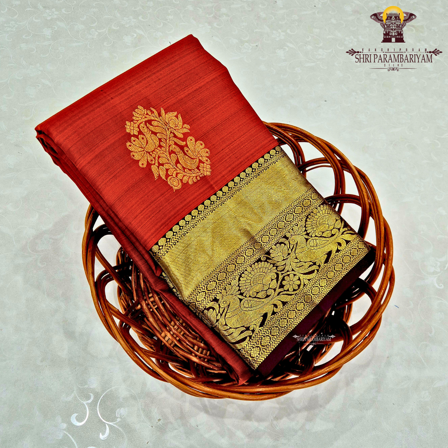 A vibrant brick red body with a rich gold zari border and pallu Saree