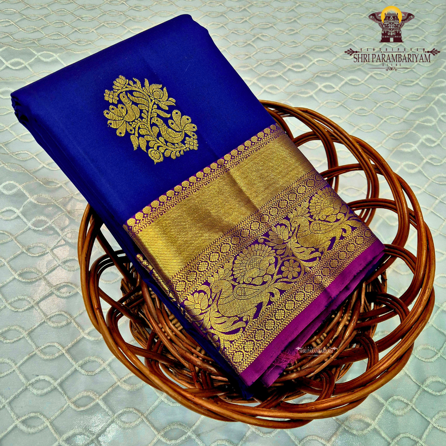 A deep royal blue with a rich gold zari border and a contrasting magenta (pink) edging Saree