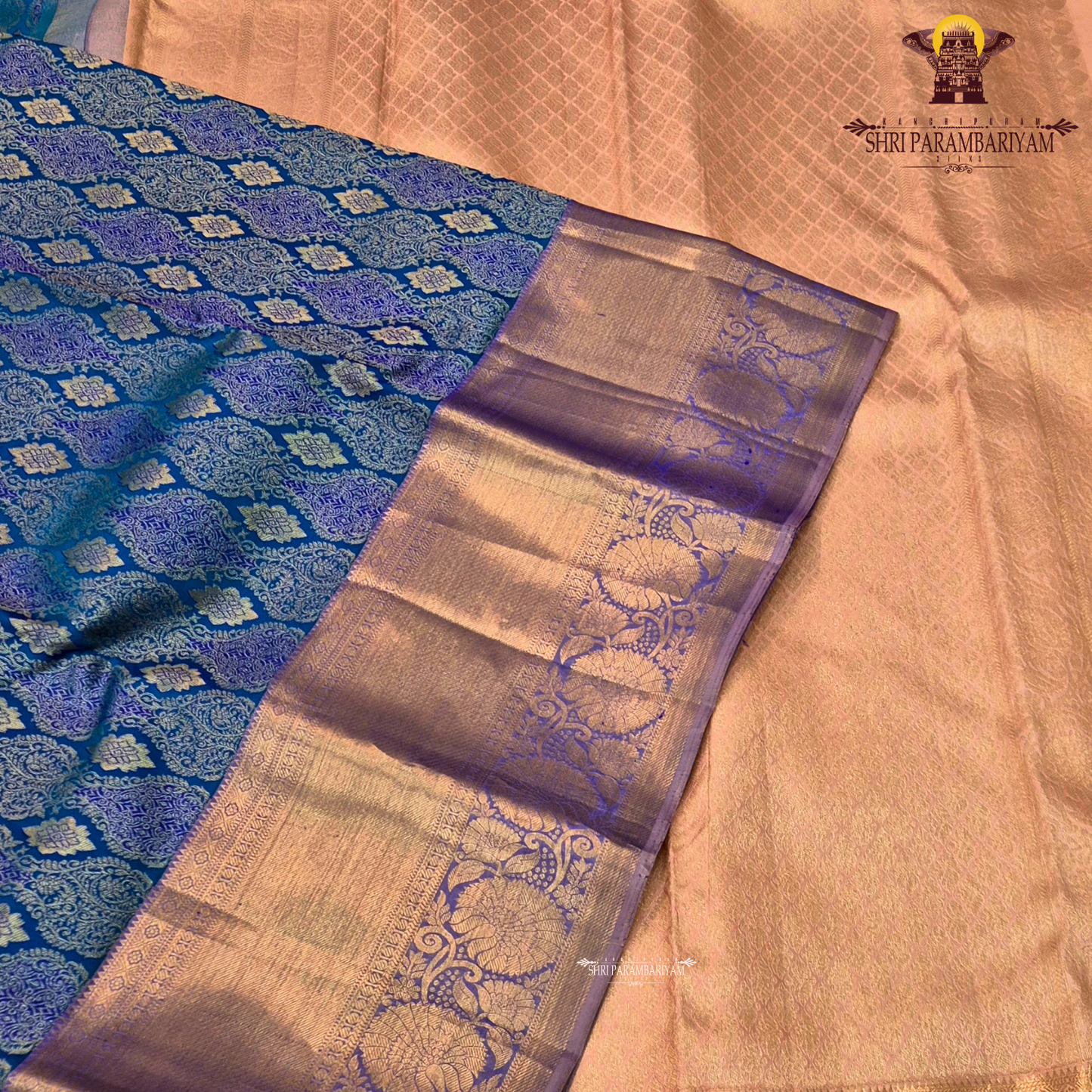 A royal blue with a lavender purple border and rich rose gold zari Saree