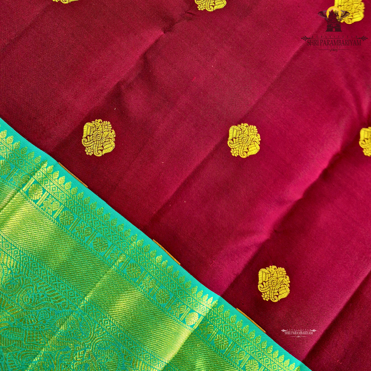 A rich Wine Magenta / Deep Rani Pink body with a contrasting Turquoise Blue Korvai Border Saree