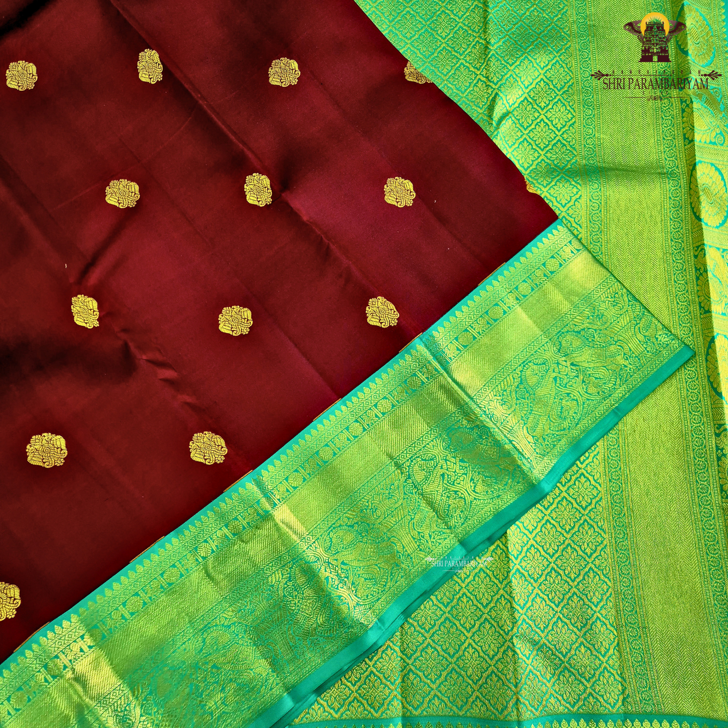 A rich Wine Magenta / Deep Rani Pink body with a contrasting Turquoise Blue Korvai Border Saree