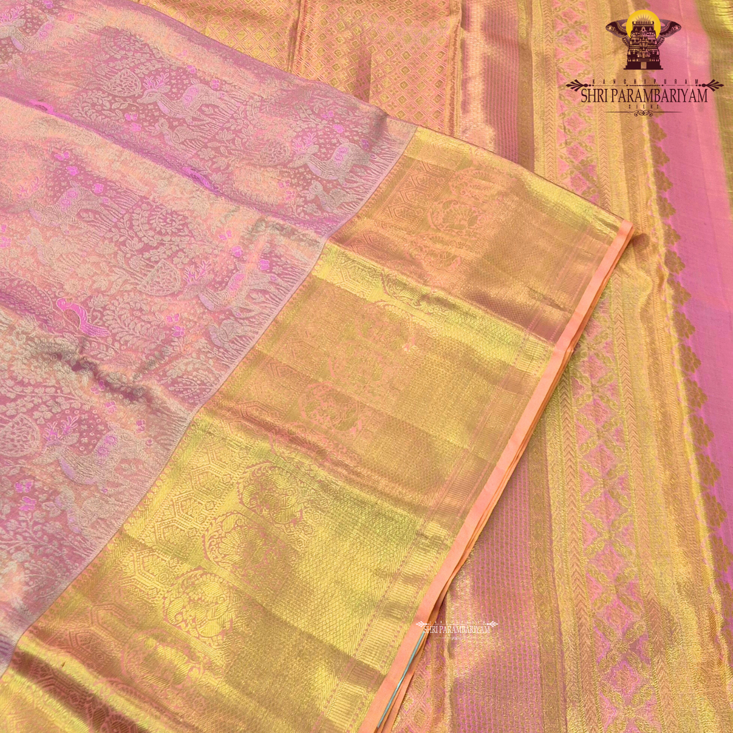 A soft and elegant peachy pink body complemented Saree
