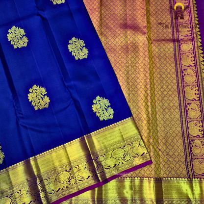 A deep royal blue with a rich gold zari border and a contrasting magenta (pink) edging Saree