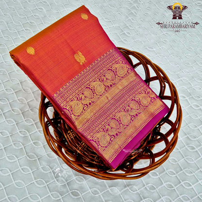 A vibrant orange with a rich gold zari border and a contrasting rani pink (magenta) edging Saree