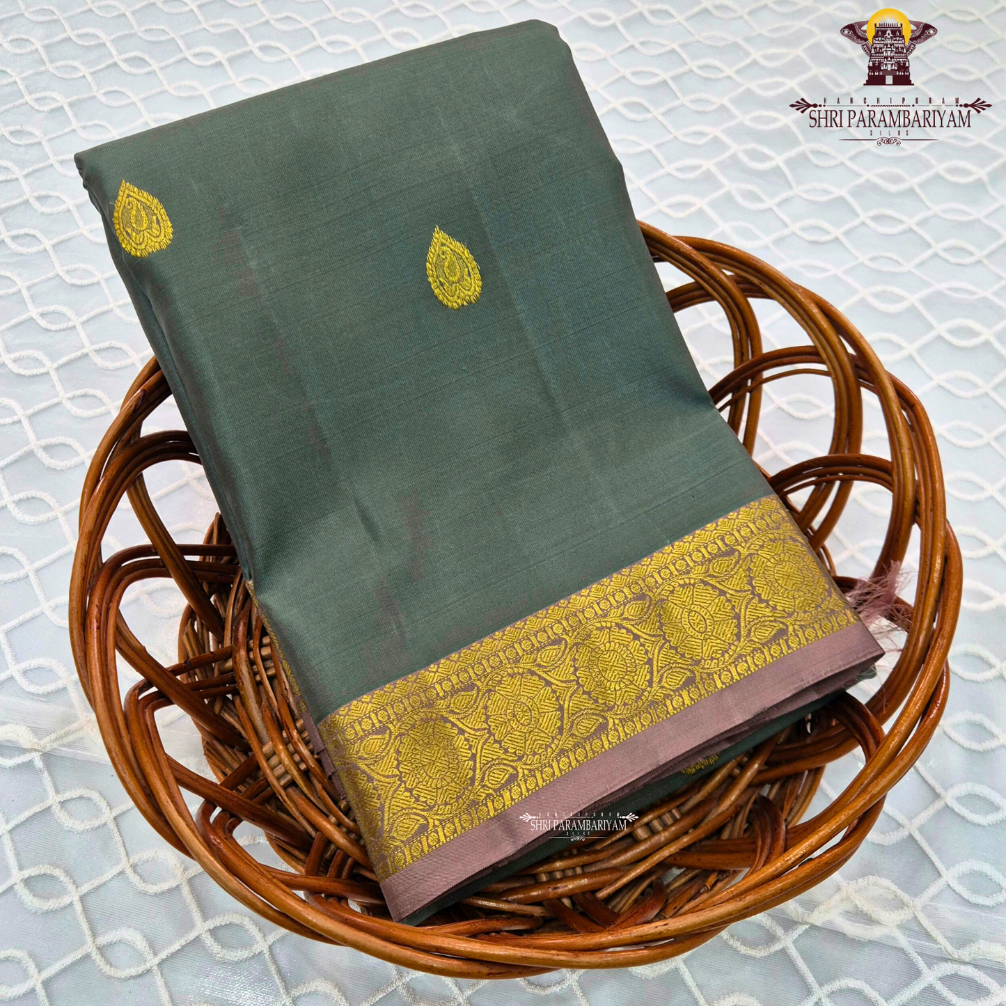 Elegant Dusty Green / Sage Green body with rich gold zari buttas, paired with a mustard gold zari 2-inch traditional border and subtle mauve selvedge edging Saree