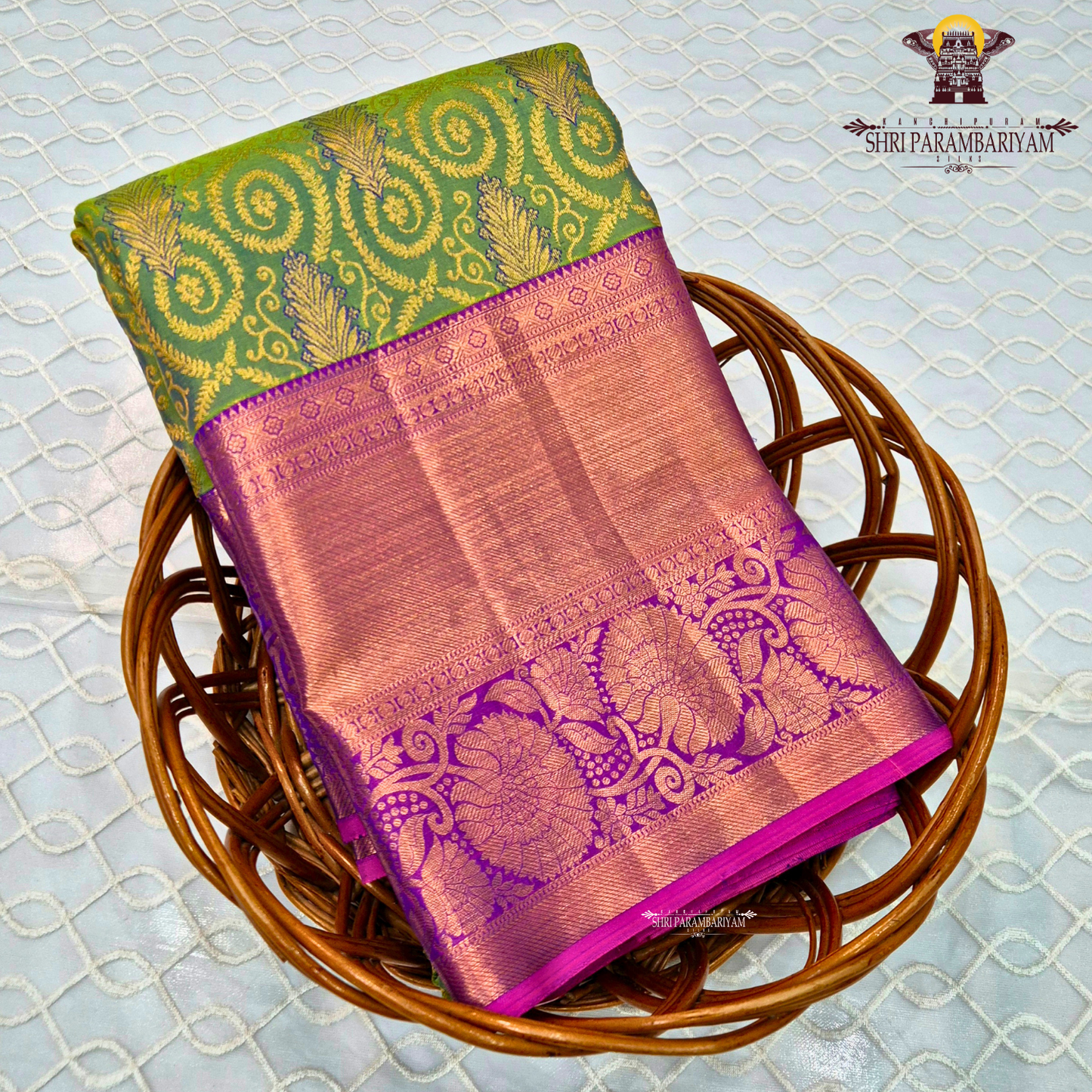 A vibrant parrot green body, paired with a rich purple (magenta-toned) korvai border Saree