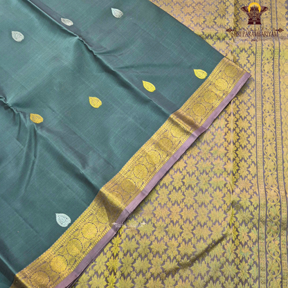 Elegant Dusty Green / Sage Green body with rich gold zari buttas, paired with a mustard gold zari 2-inch traditional border and subtle mauve selvedge edging Saree