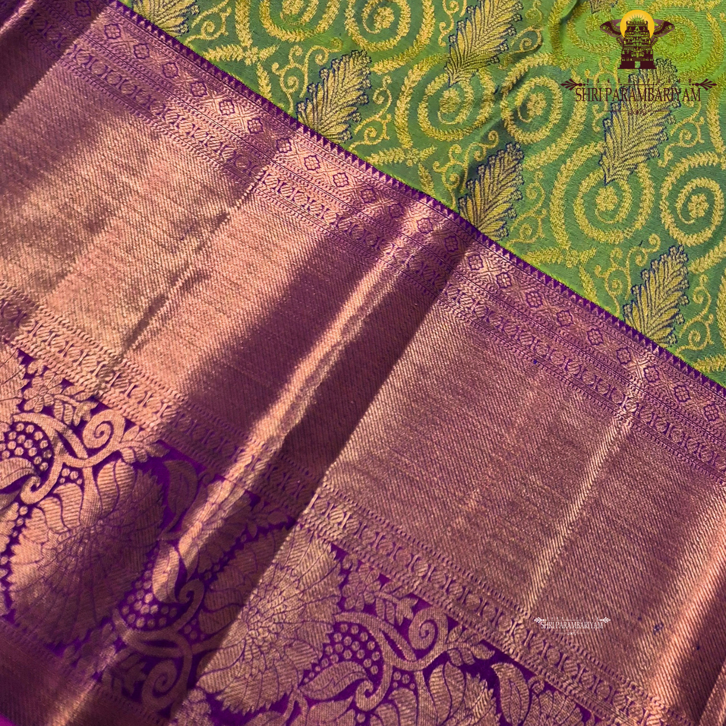 A vibrant parrot green body, paired with a rich purple (magenta-toned) korvai border Saree