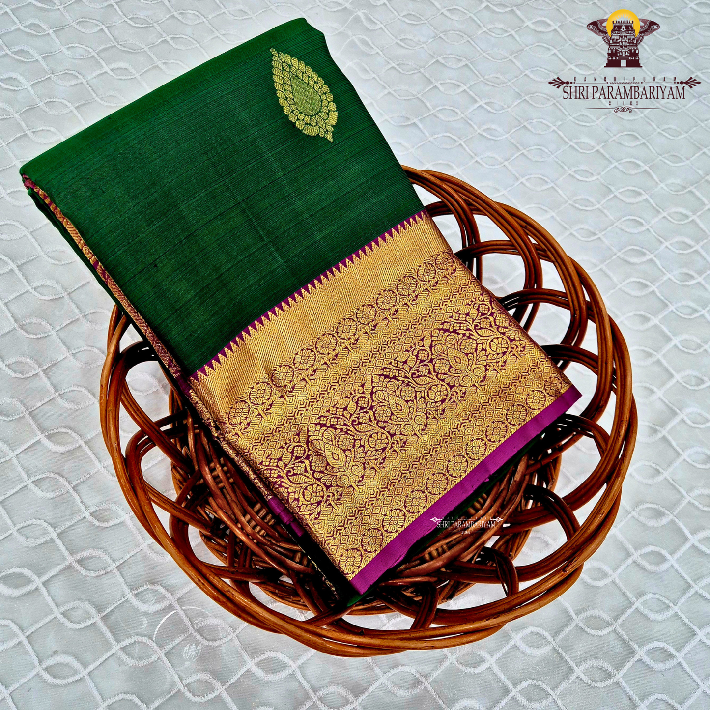 A rich bottle green with a gold zari border and a contrasting magenta (rani pink) edging Saree