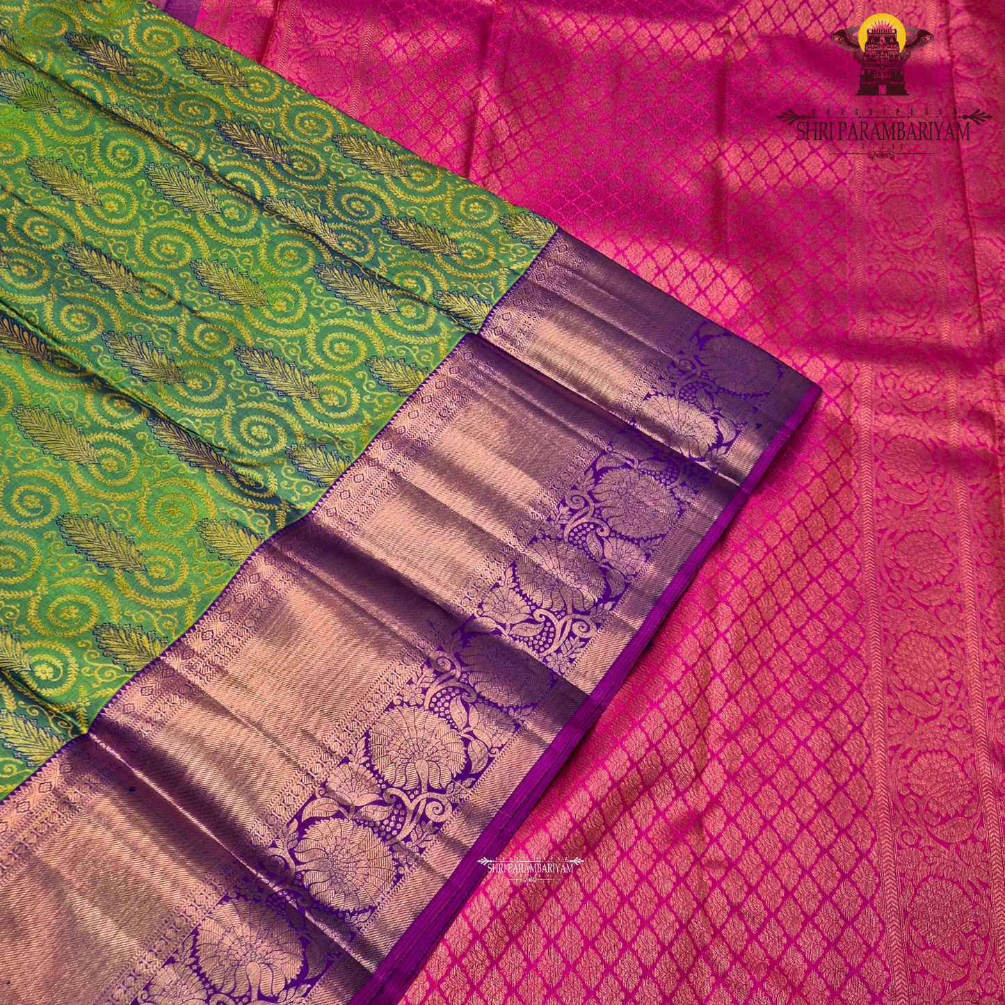 A vibrant parrot green body, paired with a rich purple (magenta-toned) korvai border Saree