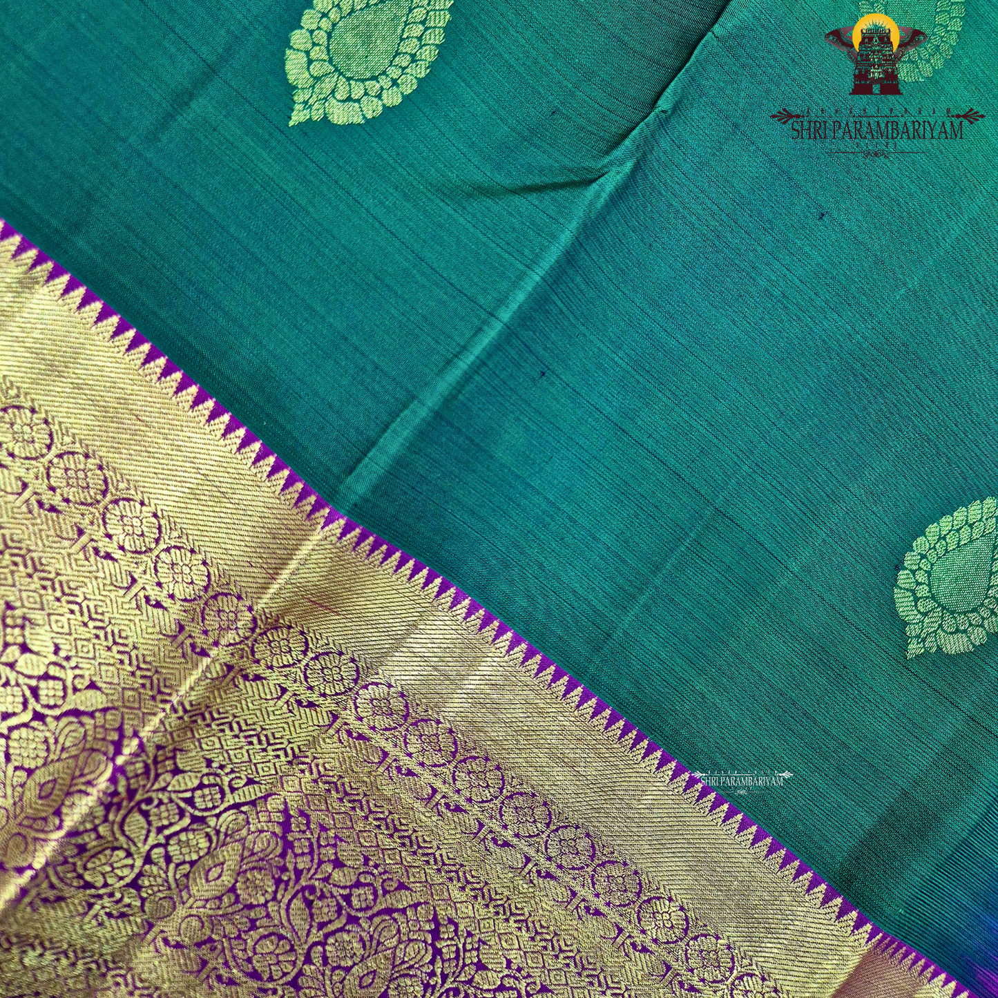 A rich bottle green with a gold zari border and a contrasting magenta (rani pink) edging Saree