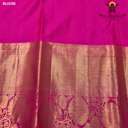 A vibrant parrot green body, paired with a rich purple (magenta-toned) korvai border Saree