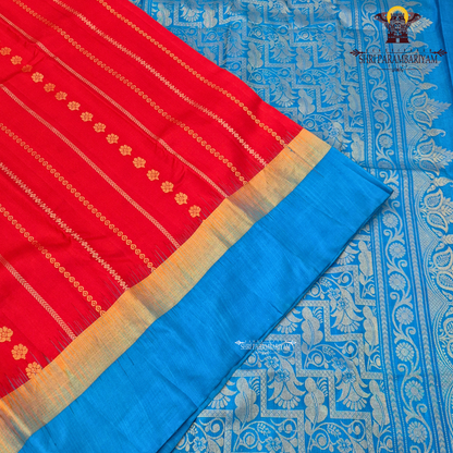 A vibrant deep red body paired with a contrasting Saree